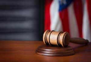 gavel on a desk with the American flag in the background