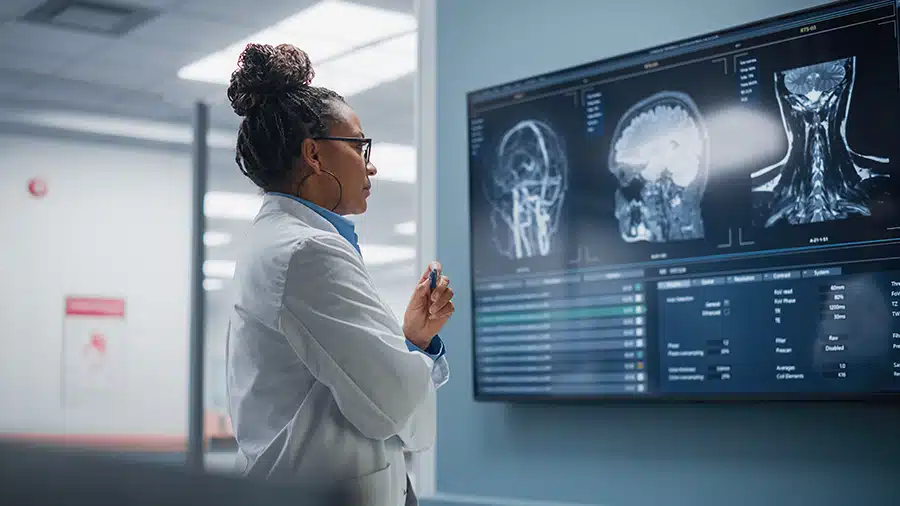 female neurologist reviewing brain scans of a worker with a traumatic brain injury