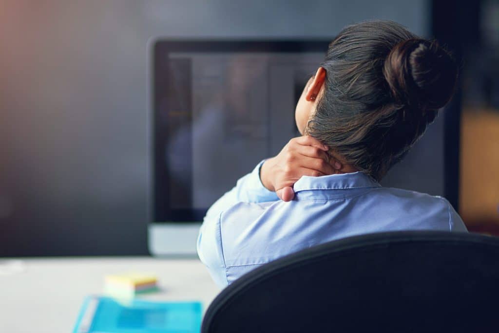 Rearview shot of a businesswoman suffering from musculoskeletal disorders at the office_musculoskeletal disorder and chronic pain