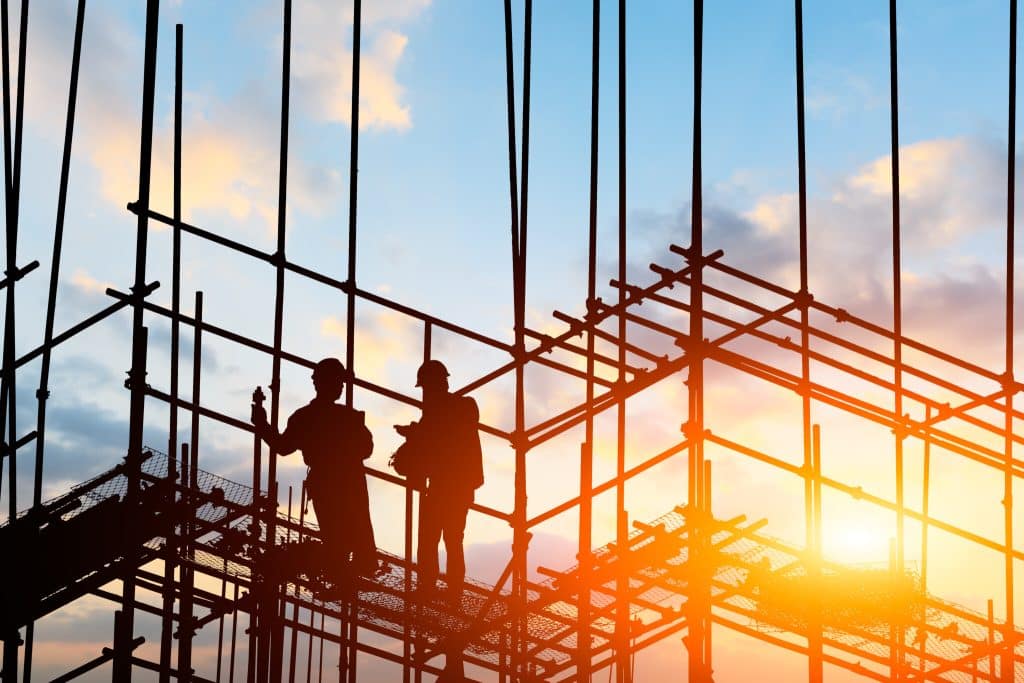 construction worker on construction site at sunset