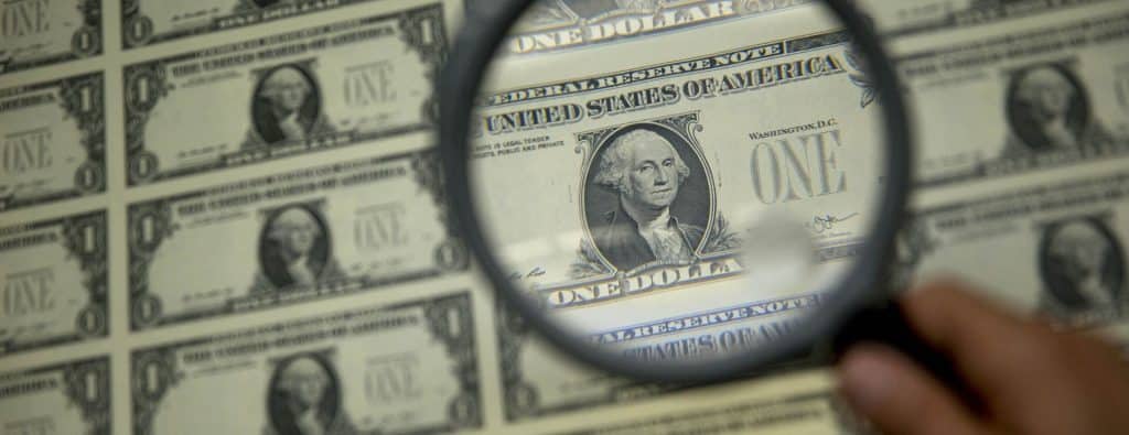 magnifying glass over a dollar bill