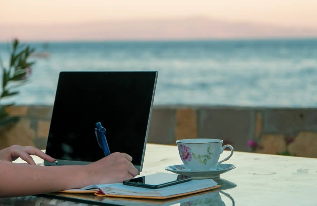 working remotely on vacation outside with a cup of tea