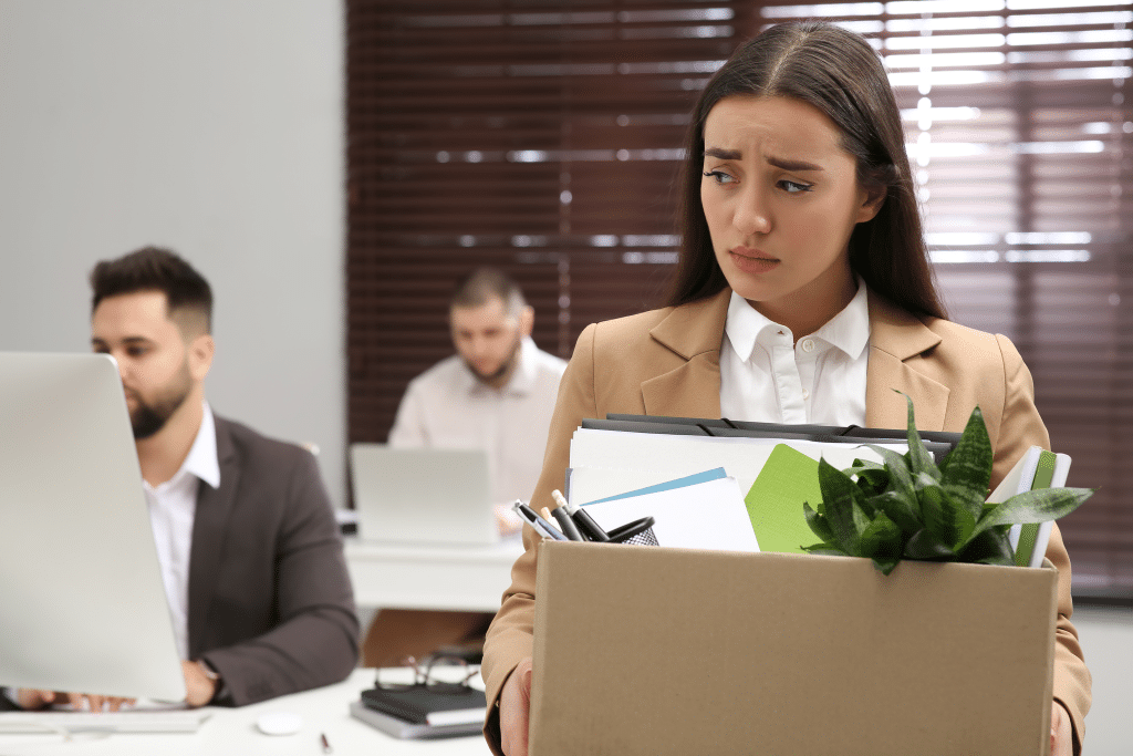 wrongfully-terminated-female-employee-leaving-her-office-with-a-box-of-items