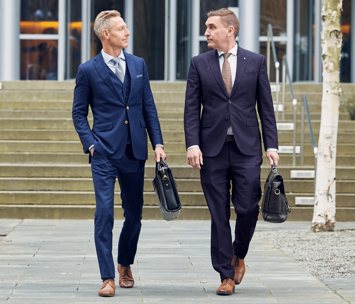 Seattle L&I attorneys Tim Emery and Patrick Reddy of Emery Reddy walking in front of the Seattle Courthouse