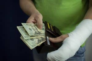 Worker with hand injury puts cash into wallet a week sooner following an injury.