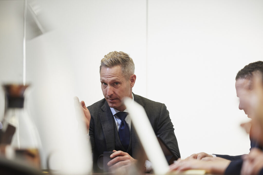 Emery Reddy Attorney Timothy Emery speaking to his salary transparency team in the conference room.