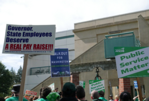 State employees gathered outside the Labor and Industries Building in Tumwater as part of a statewide walkout to demand fair wages and safe staffing levels. (Laurel Demkovich/Washington State Standard)