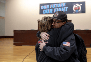 Boeing Machinists union steward and fuel cell mechanic Jon Voss hug